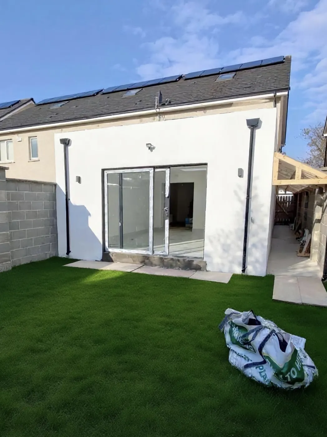 Rear home extension with glazed sliding doors opening to garden