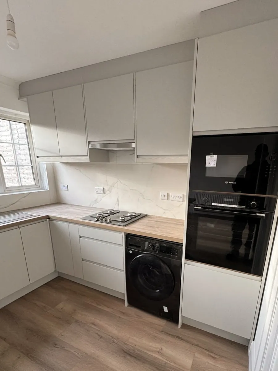 Kitchen renovation — Tallaght, Dublin. Modern grey handleless kitchen with marble splashback.